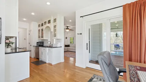 a kitchen with a refrigerator and a dining table