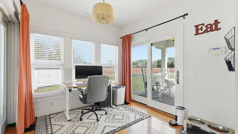 a view of a workspace with furniture and a window