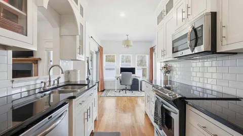 a kitchen with stainless steel appliances granite countertop a sink stove and refrigerator
