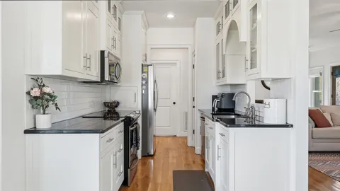 a kitchen with stainless steel appliances granite countertop a sink stove and refrigerator
