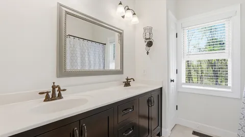 a bathroom with a sink double vanity and a mirror