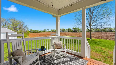 a view of a chair and tables in the patio