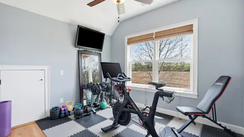 a view of a livingroom with workspace and a window
