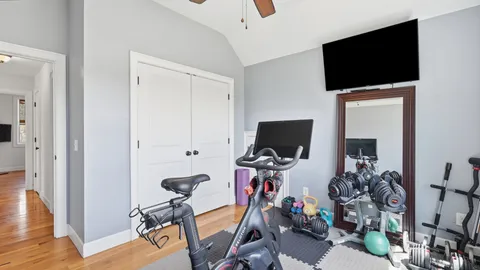 a view of a workspace with furniture and a flat screen tv