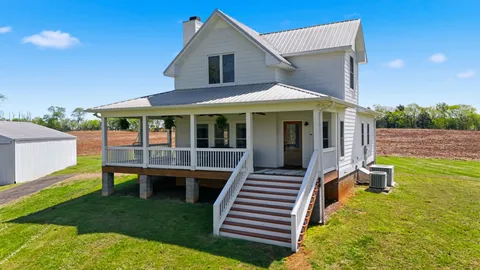 a front view of a house with a yard table and chairs