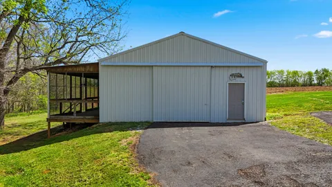 a front view of house with yard and outdoor seating