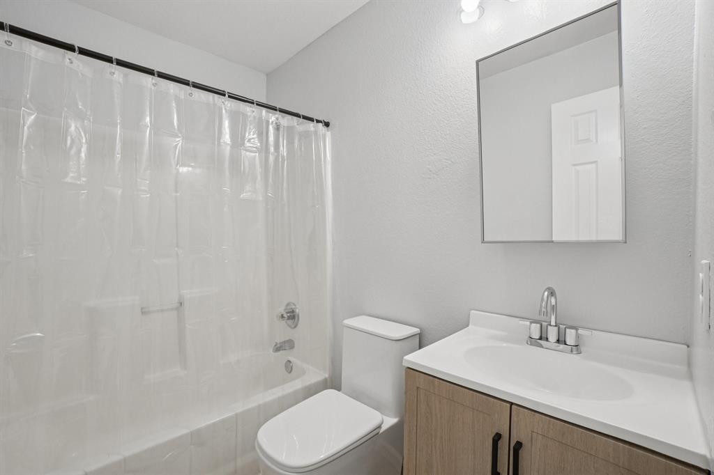 4021 Preferred Place Dallas, TX 75237 - Photo 16 of 25 a bathroom with a sink a toilet and shower