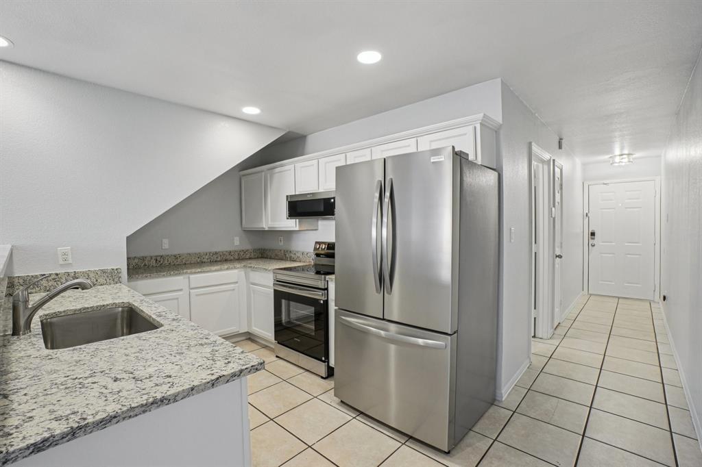 4021 Preferred Place Dallas, TX 75237 - Photo 3 of 25 a kitchen with stainless steel appliances granite countertop a refrigerator sink and stove