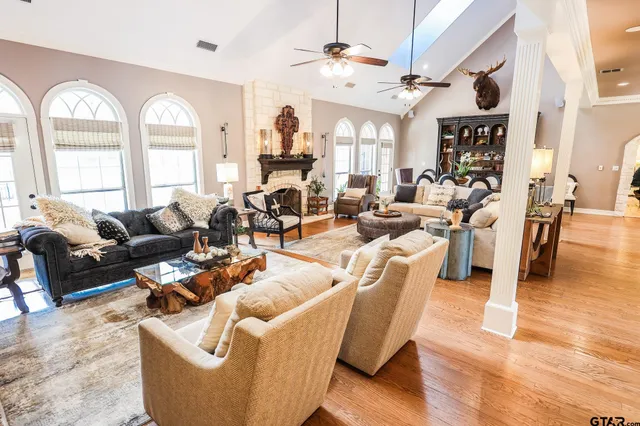 a living room with furniture fireplace and a large window