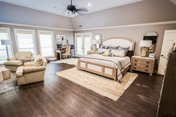 a spacious bedroom with a bed couch and a window