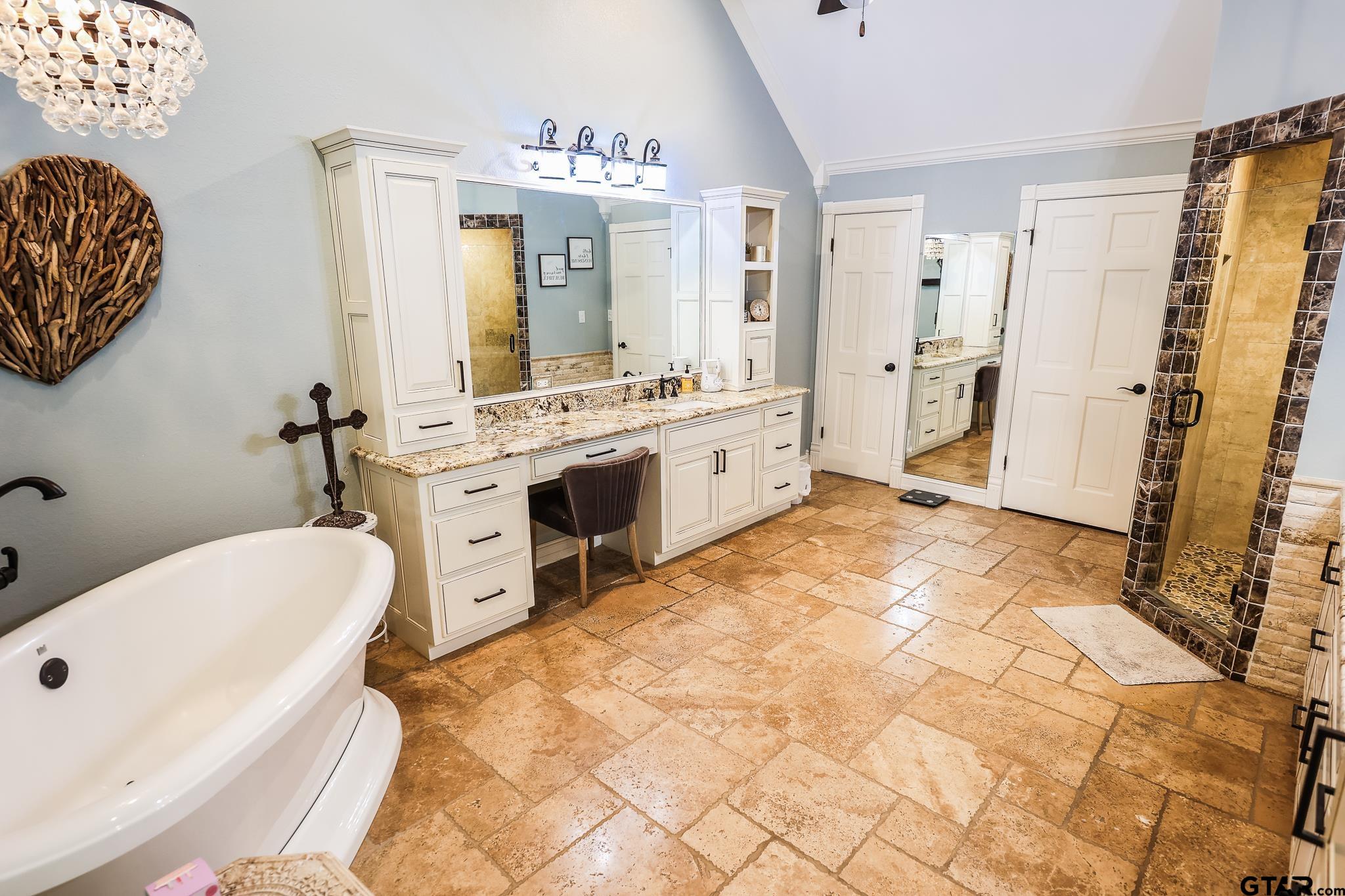 1415 West Sabine Street Carthage, TX 75633 - Photo 17 of 44 a spacious bathroom with a tub sink and mirror