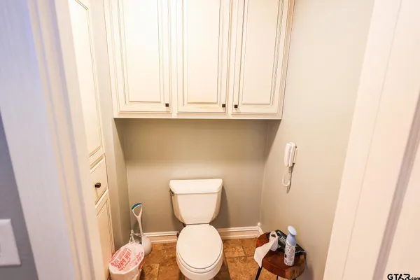 a bathroom with a toilet a sink and a window