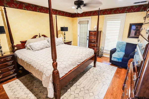 a bedroom with a bed and wooden floor