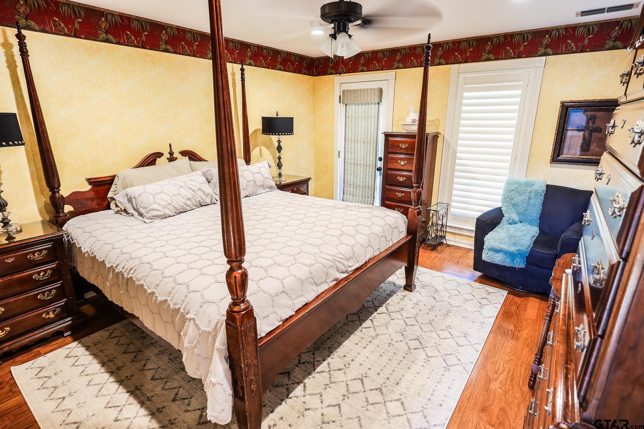 1415 West Sabine Street Carthage, TX 75633 - Photo 22 of 44 a bedroom with a bed and wooden floor