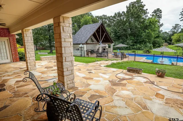 a view of house with backyard and glass windows