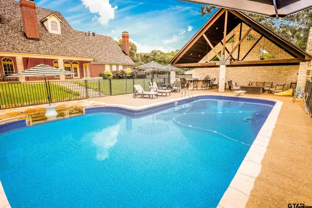 a view of a field with a trees in the background