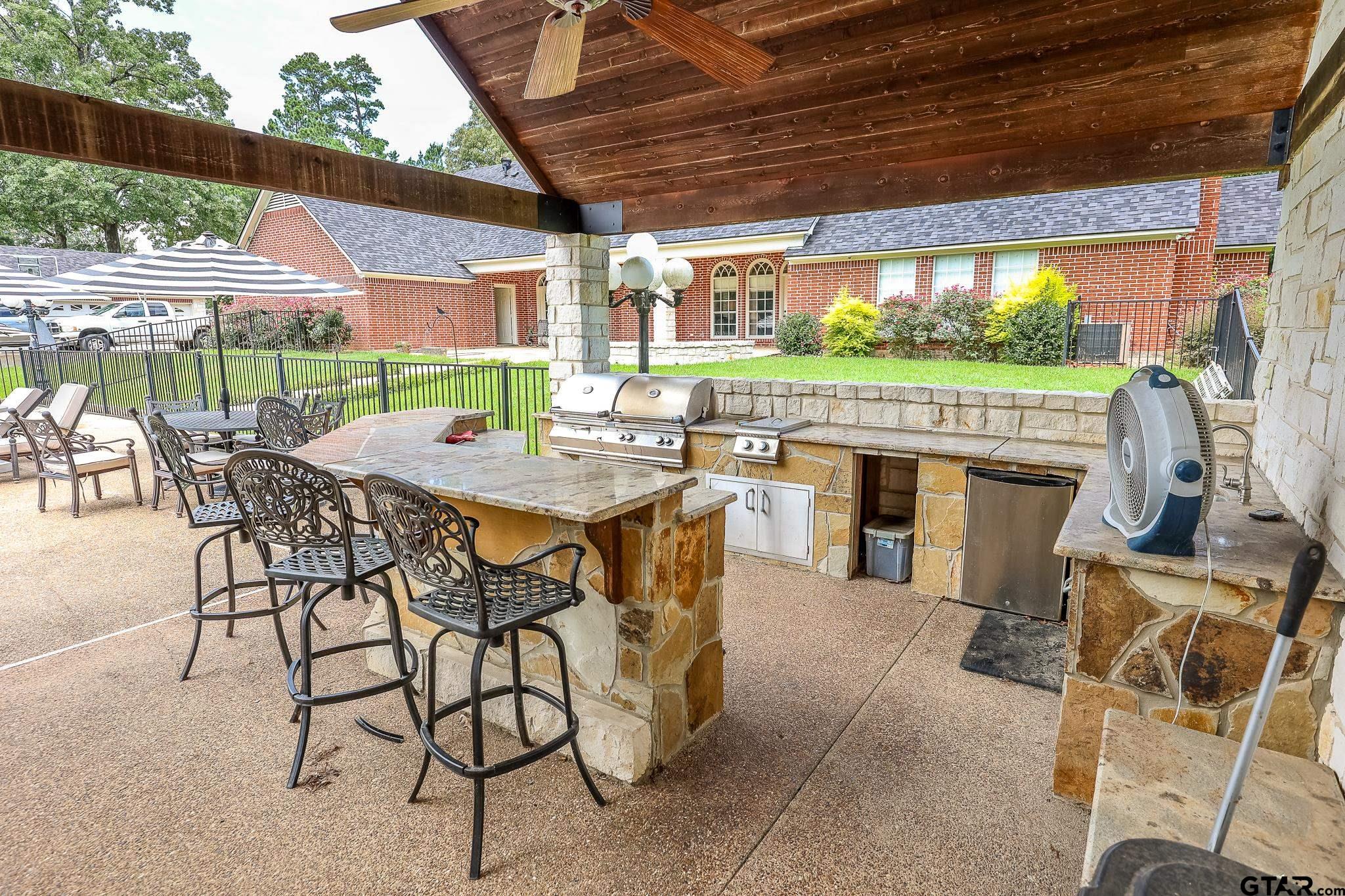 1415 West Sabine Street Carthage, TX 75633 - Photo 35 of 44 a view of a patio with a table and chairs