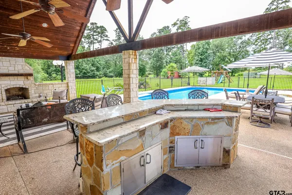 a view of yard with swimming pool and bench