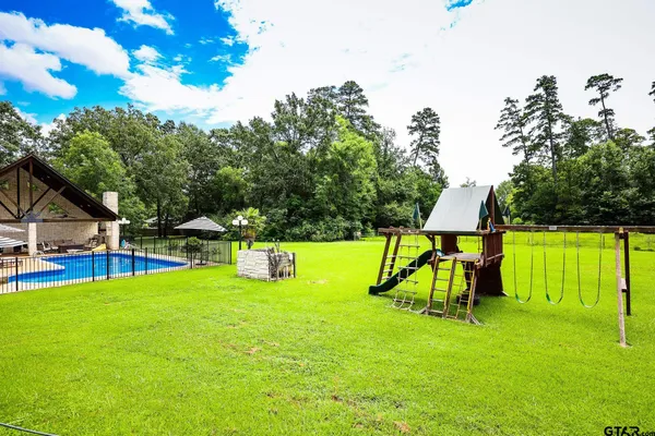 an aerial view of a house with outdoor space patio and trees all around