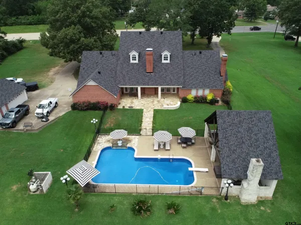 an aerial view of a house with swimming pool garden and outdoor seating