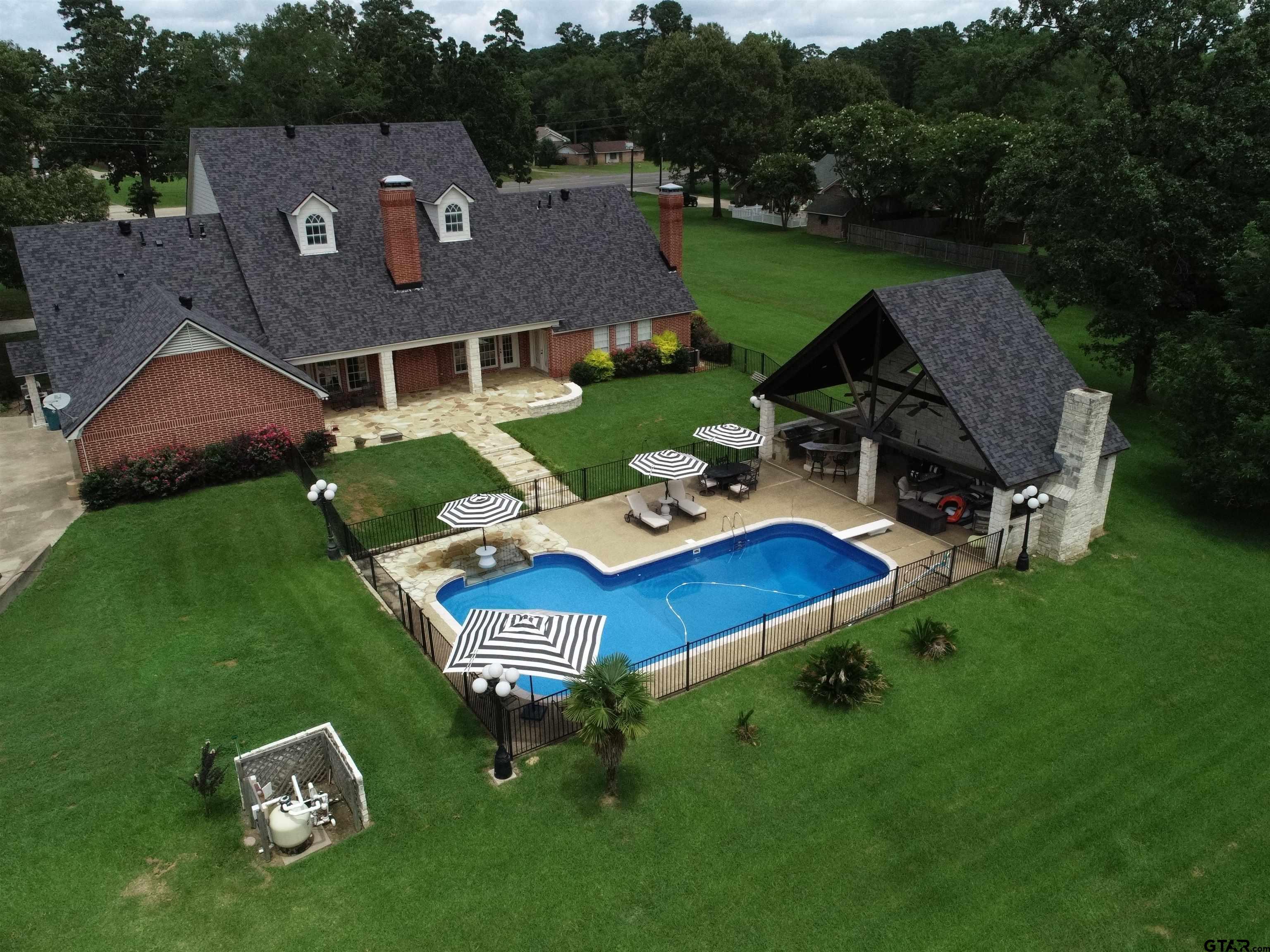 1415 West Sabine Street Carthage, TX 75633 - Photo 39 of 44 an aerial view of a house with swimming pool garden and outdoor seating