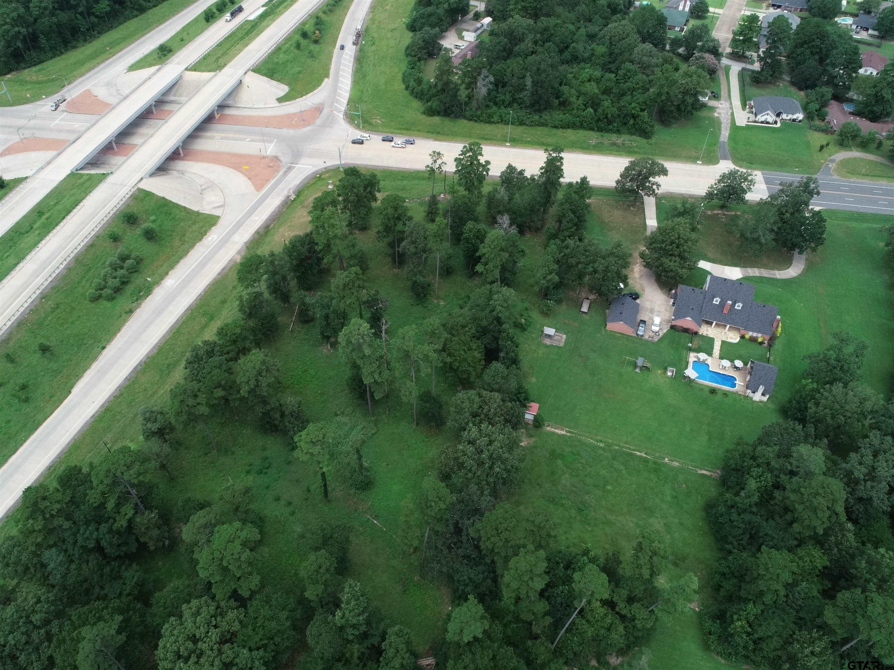 1415 West Sabine Street Carthage, TX 75633 - Photo 42 of 44 a view of a lake with a yard