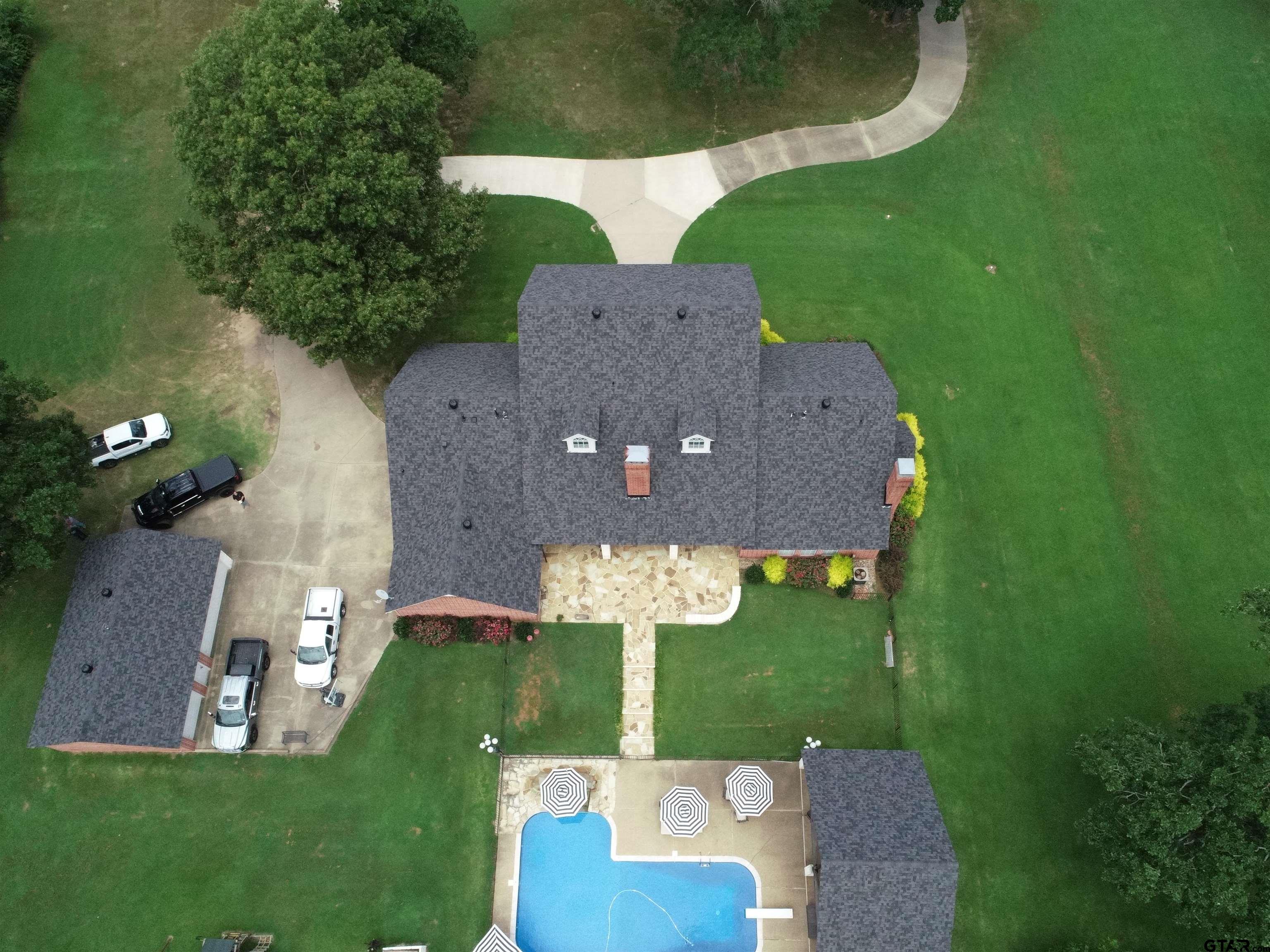 1415 West Sabine Street Carthage, TX 75633 - Photo 43 of 44 an aerial view of a house with garden space and a lake view