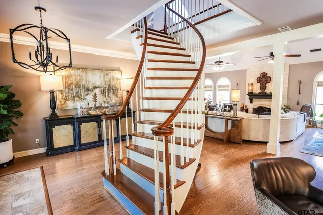 a view of living room kitchen with furniture and wooden floor