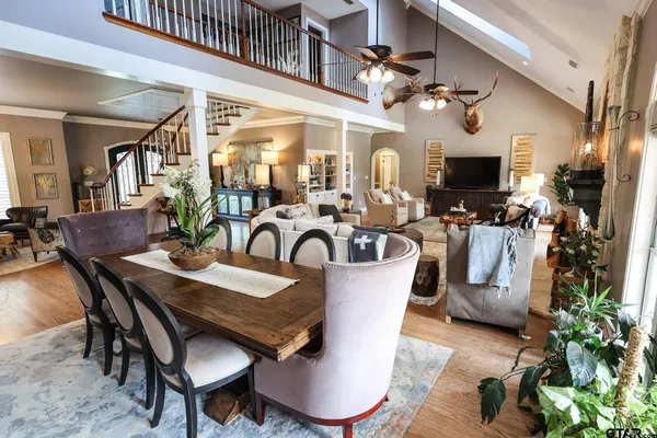 a view of a dining room with furniture a chandelier and wooden floor
