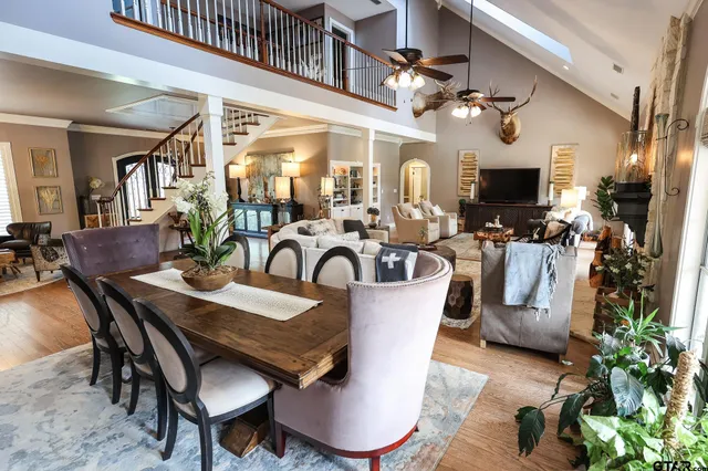 a view of a dining room with furniture a chandelier and wooden floor