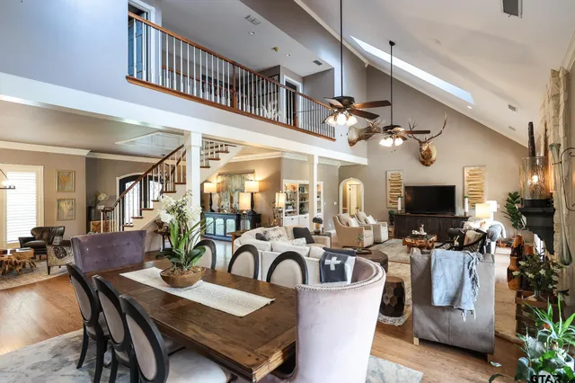 a living room with furniture a flat screen tv and kitchen view