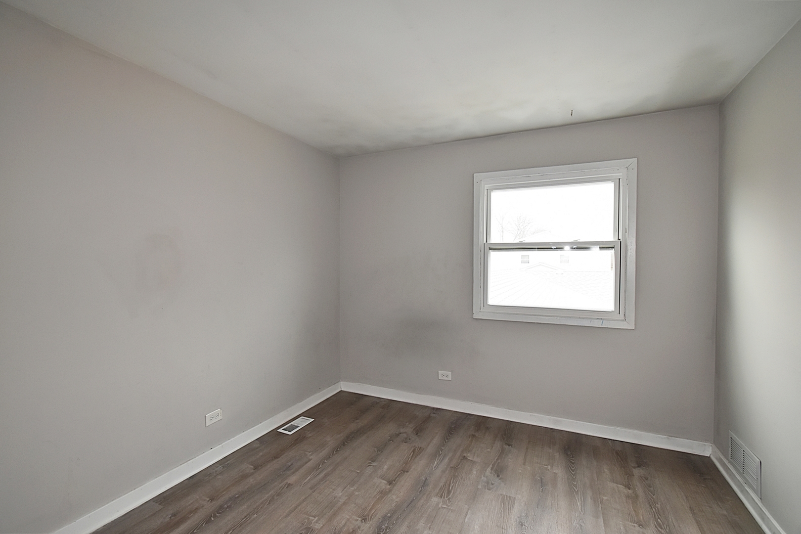 1362 South Glen Circle, Unit A Aurora, IL 60506 - Photo 11 of 17 an empty room with wooden floor and windows