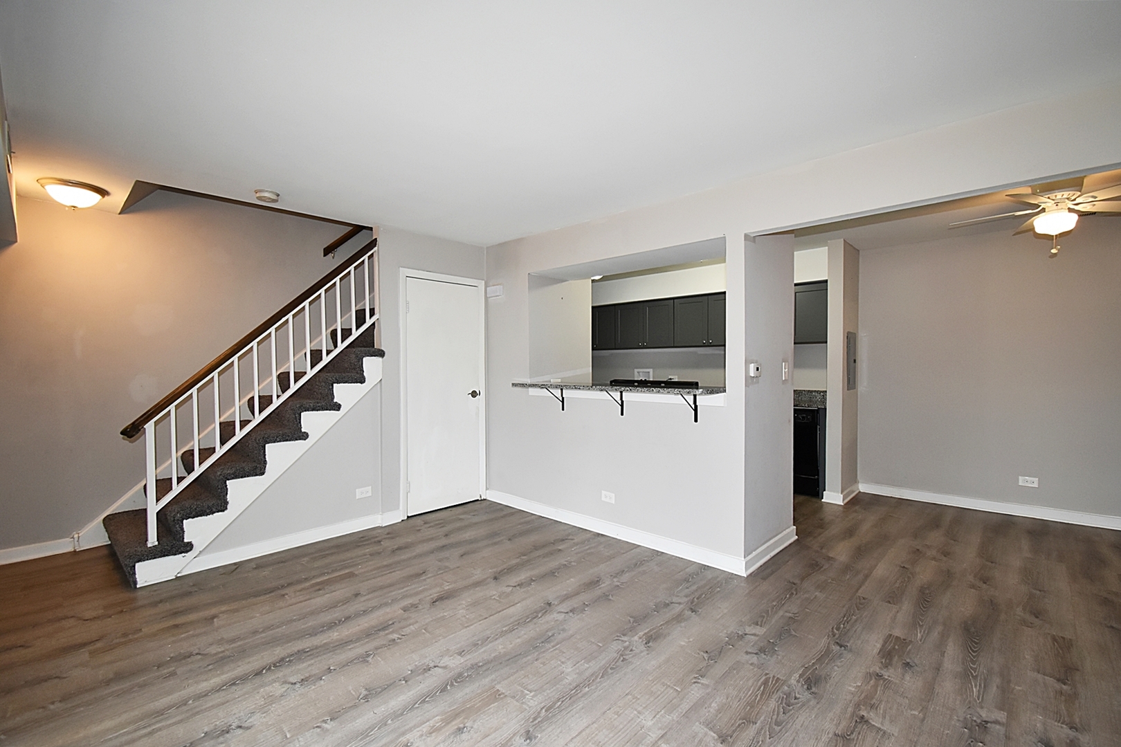 1362 South Glen Circle, Unit A Aurora, IL 60506 - Photo 14 of 17 a view of a livingroom with wooden floor and staircase