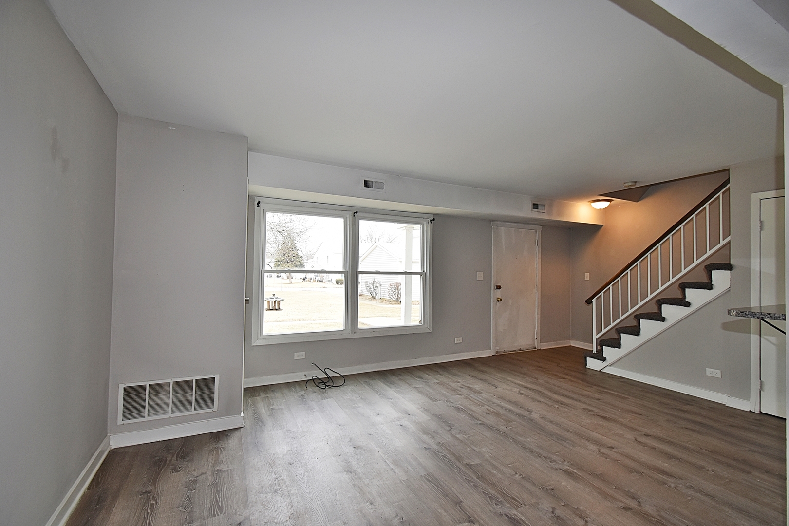 1362 South Glen Circle, Unit A Aurora, IL 60506 - Photo 4 of 17 a view of an empty room with wooden floor and a window