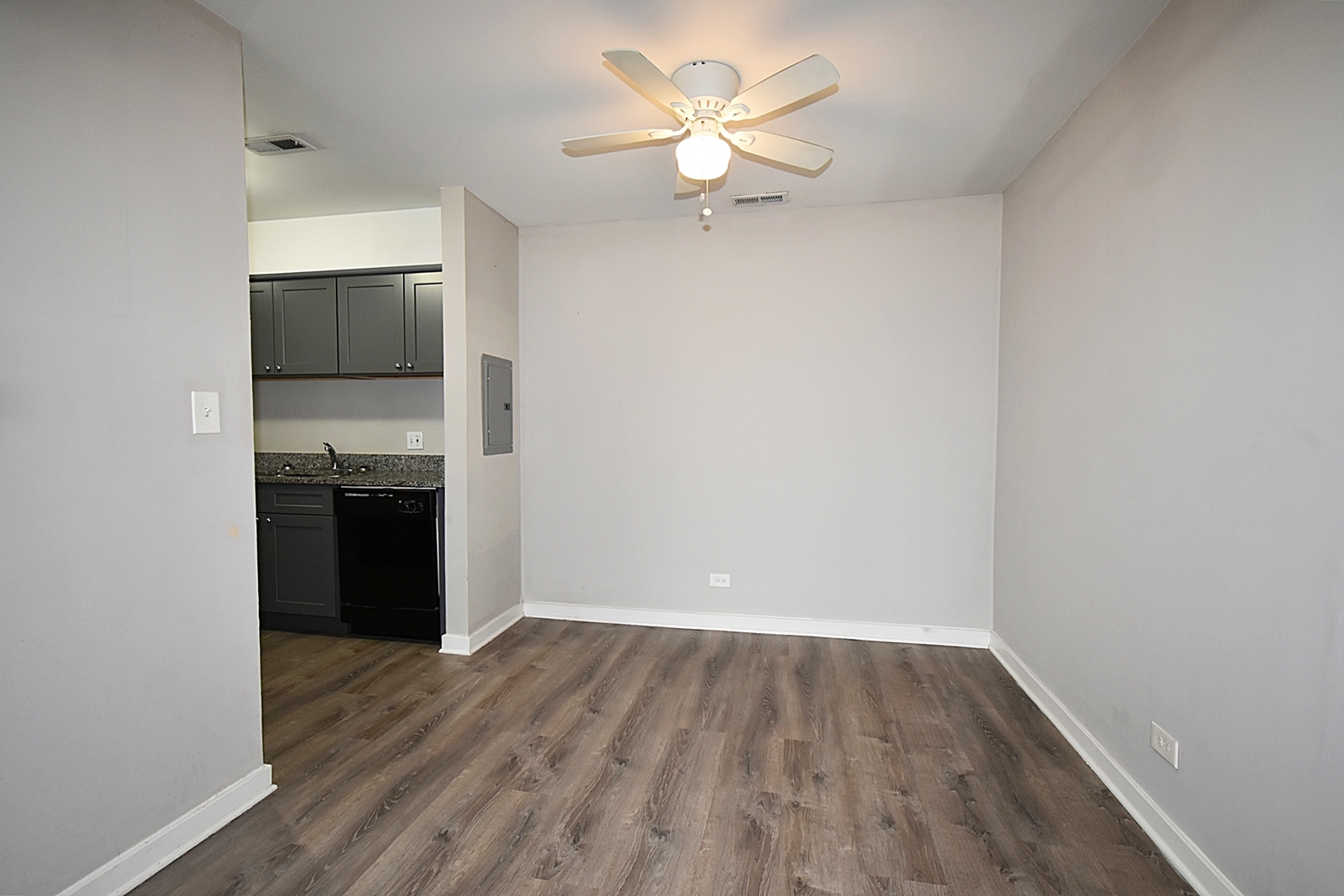 1362 South Glen Circle, Unit A Aurora, IL 60506 - Photo 7 of 17 wooden floor in an empty room with a kitchen