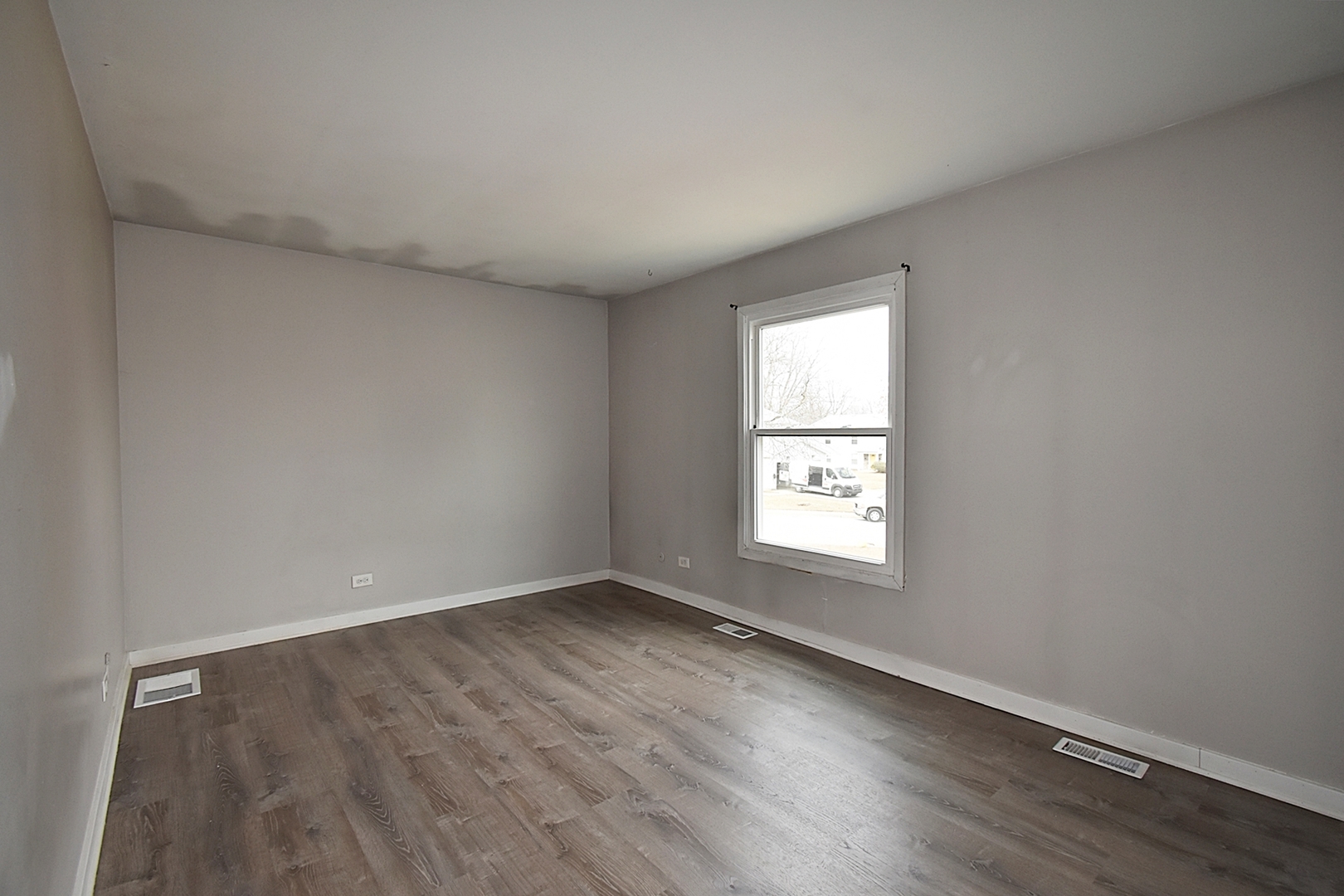 1362 South Glen Circle, Unit A Aurora, IL 60506 - Photo 10 of 17 an empty room with wooden floor and windows