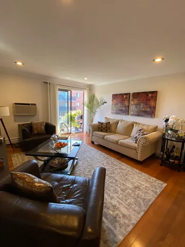 a living room with furniture rug and window