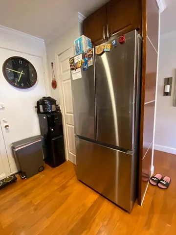 a metallic refrigerator freezer sitting in a kitchen