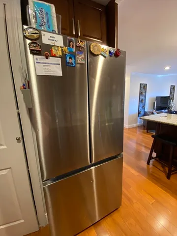 a view of a refrigerator in kitchen and a microwave