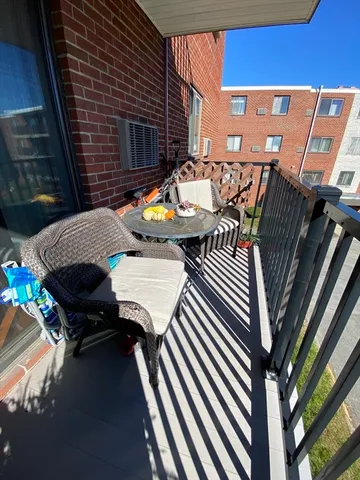 a view of a patio with couple of chairs and a fire pit