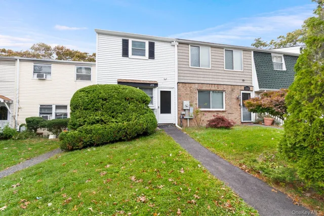 a view of a house with a backyard and a garden