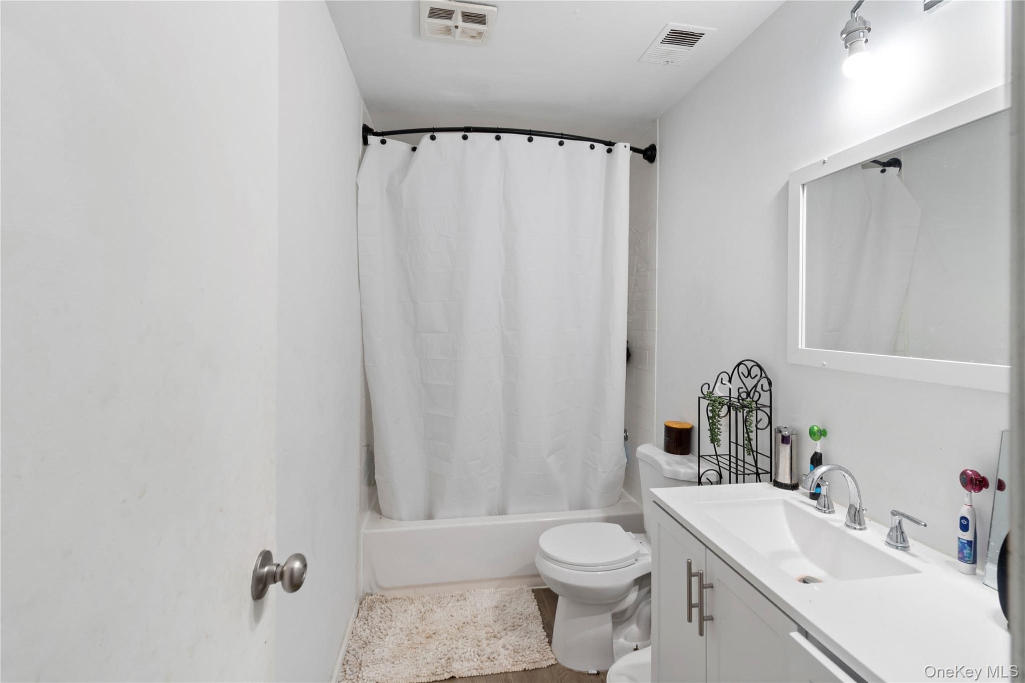 231 Hill Rise Calverton, NY 11933 - Photo 11 of 14 a bathroom with a sink toilet and shower