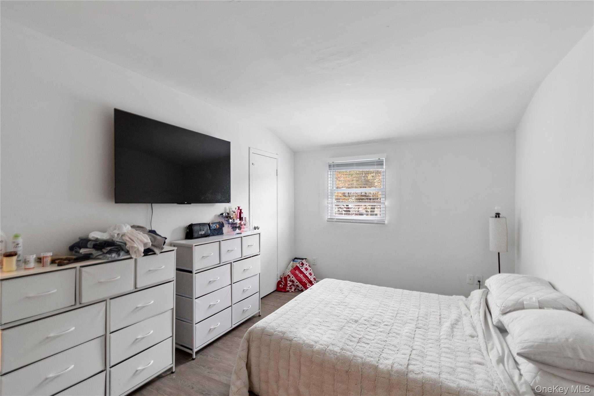 231 Hill Rise Calverton, NY 11933 - Photo 10 of 14 a bedroom with bed and flat tv screen on the dresser