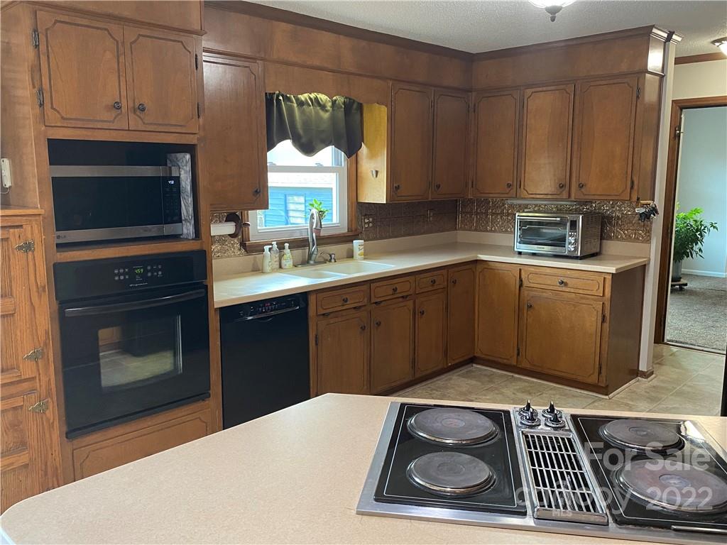 1539 Cobblestone Court Fort Mill, SC 29708 - Photo 16 of 41 a kitchen with a sink and cabinets