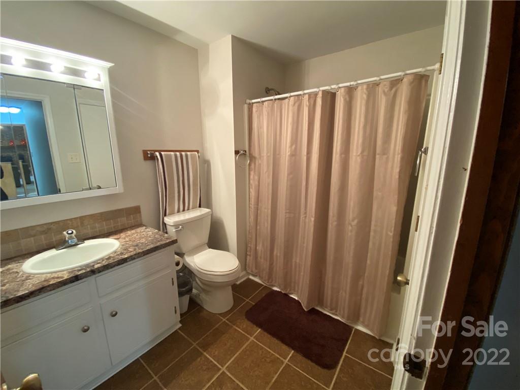 1539 Cobblestone Court Fort Mill, SC 29708 - Photo 27 of 41 a bathroom with a granite countertop sink toilet and shower