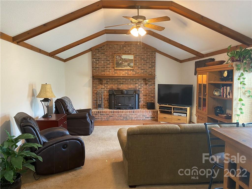 1539 Cobblestone Court Fort Mill, SC 29708 - Photo 8 of 41 a living room with furniture a flat screen tv and a fireplace