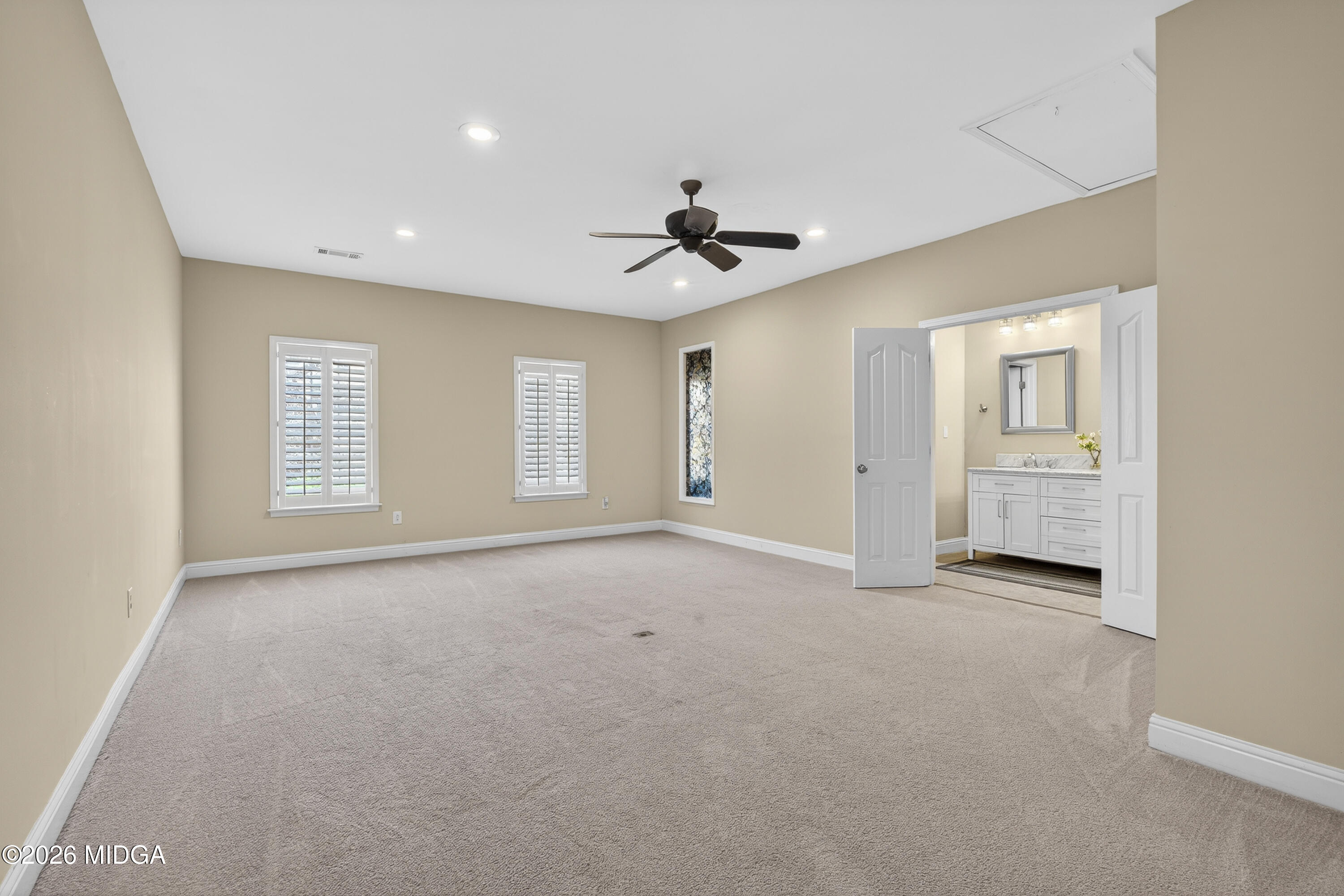 855 Tufthunter Macon, GA 31210 - Photo 52 of 86 an empty room with chandelier fan and windows