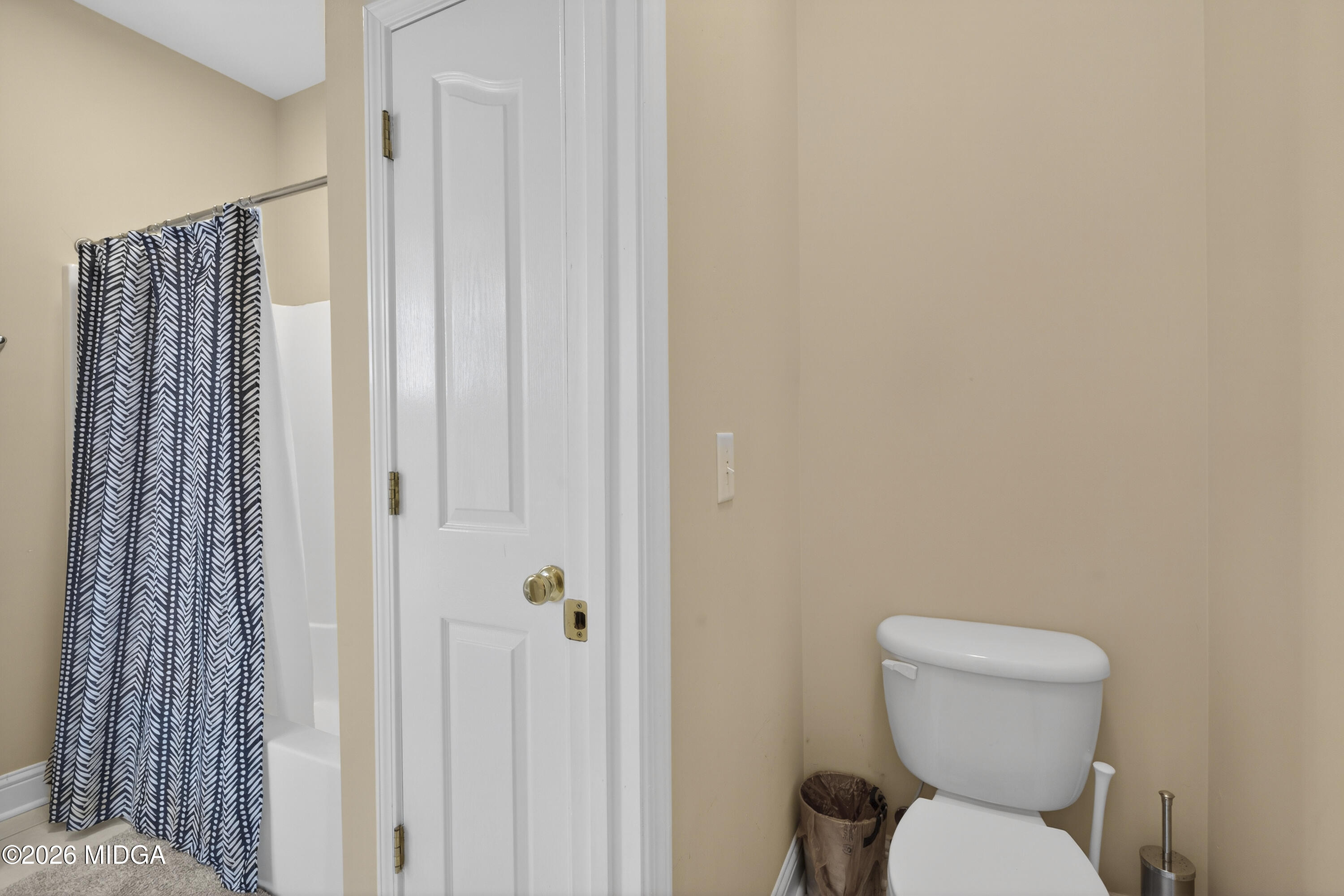 855 Tufthunter Macon, GA 31210 - Photo 66 of 87 a white toilet sitting next to a shower curtain