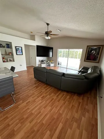 a living room with furniture flat screen tv and a fireplace