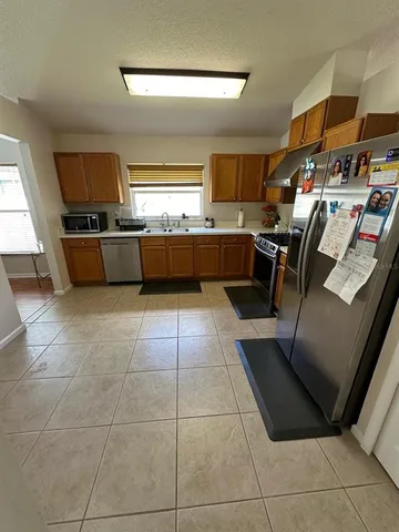 a kitchen with stainless steel appliances kitchen island granite countertop a sink and cabinets